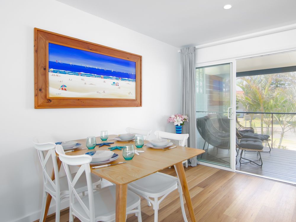 Open plan dining with large sliding doors to balcony