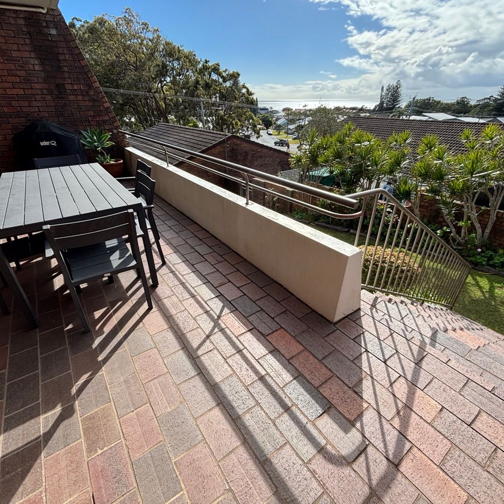 Downstairs balcony and backyard. 
