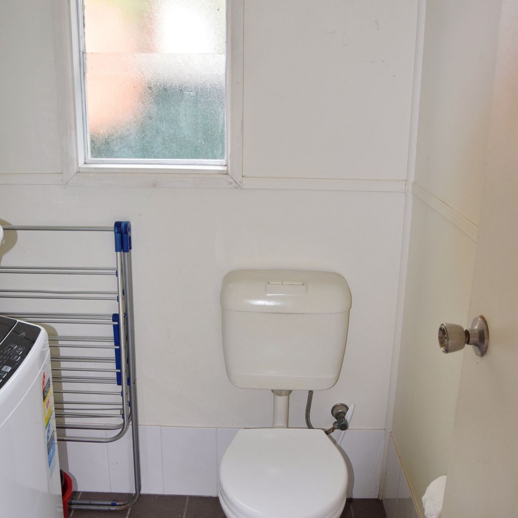 Separate toilet in laundry.