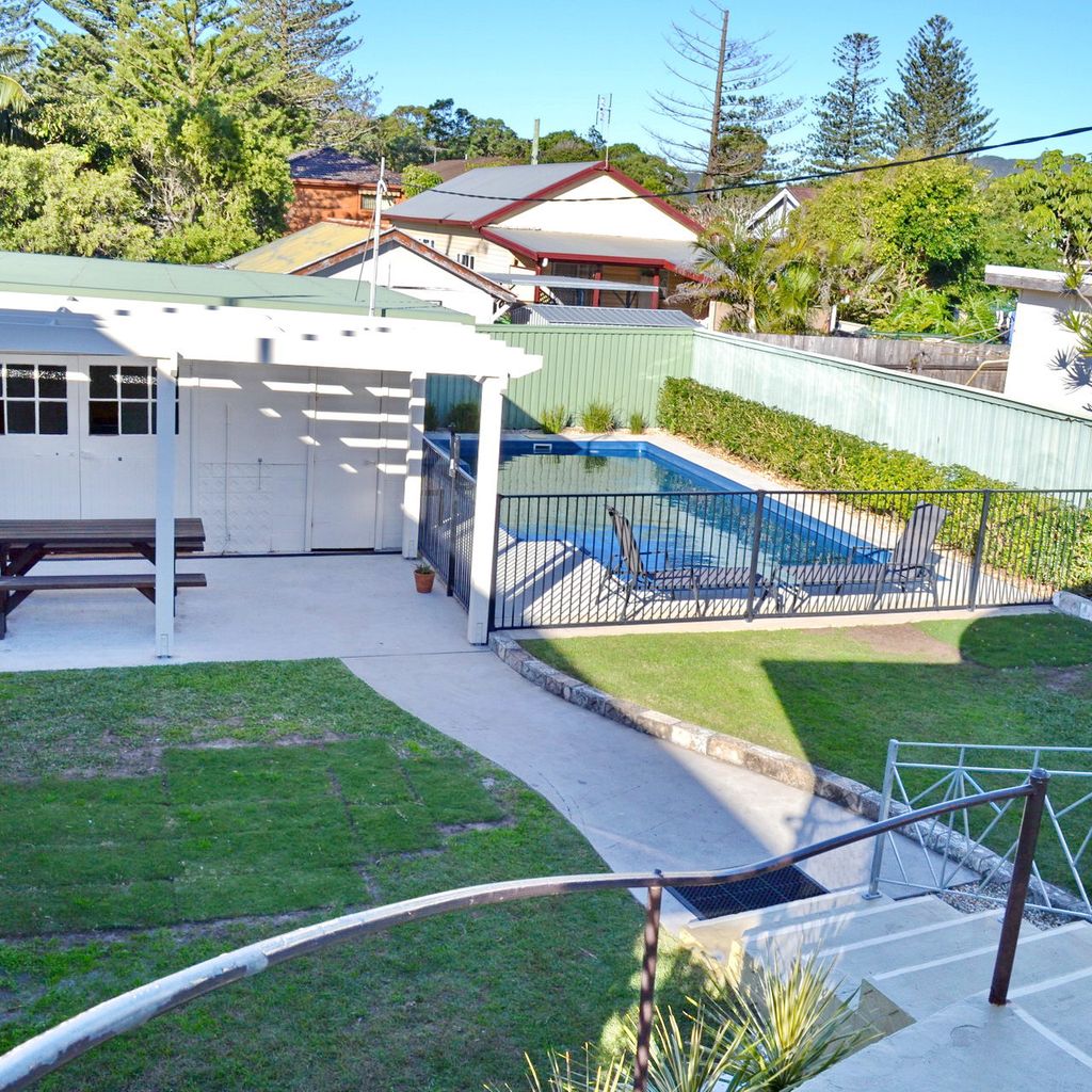 Backyard with pool and rumpus room.