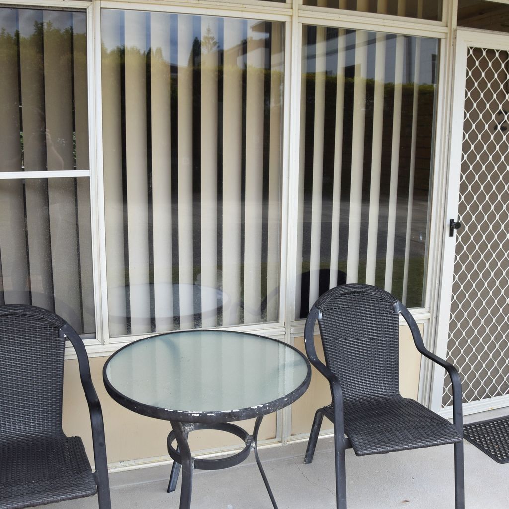 Table and chairs out the front of unit 2.