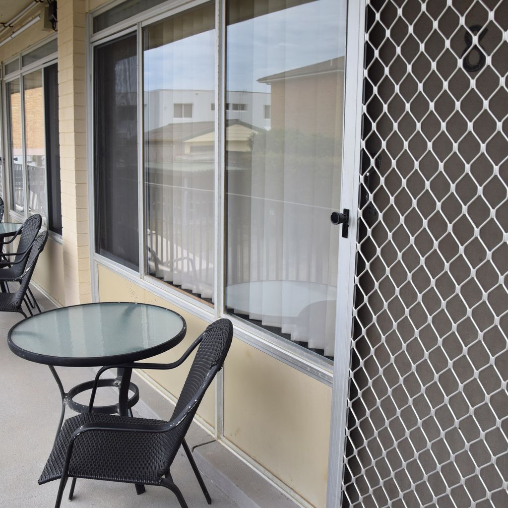 Table and chairs out the front of unit 8.