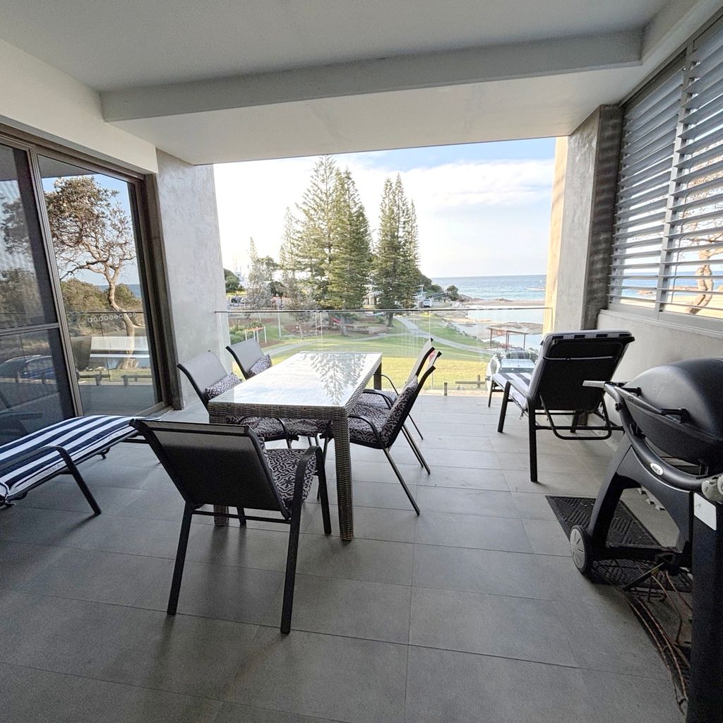 Balcony and outdoor dining area with view. 