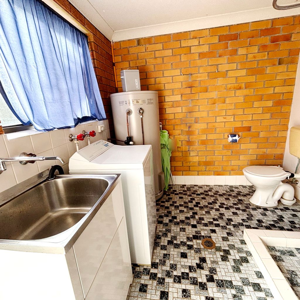 Outdoor combined laundry and bathroom. 