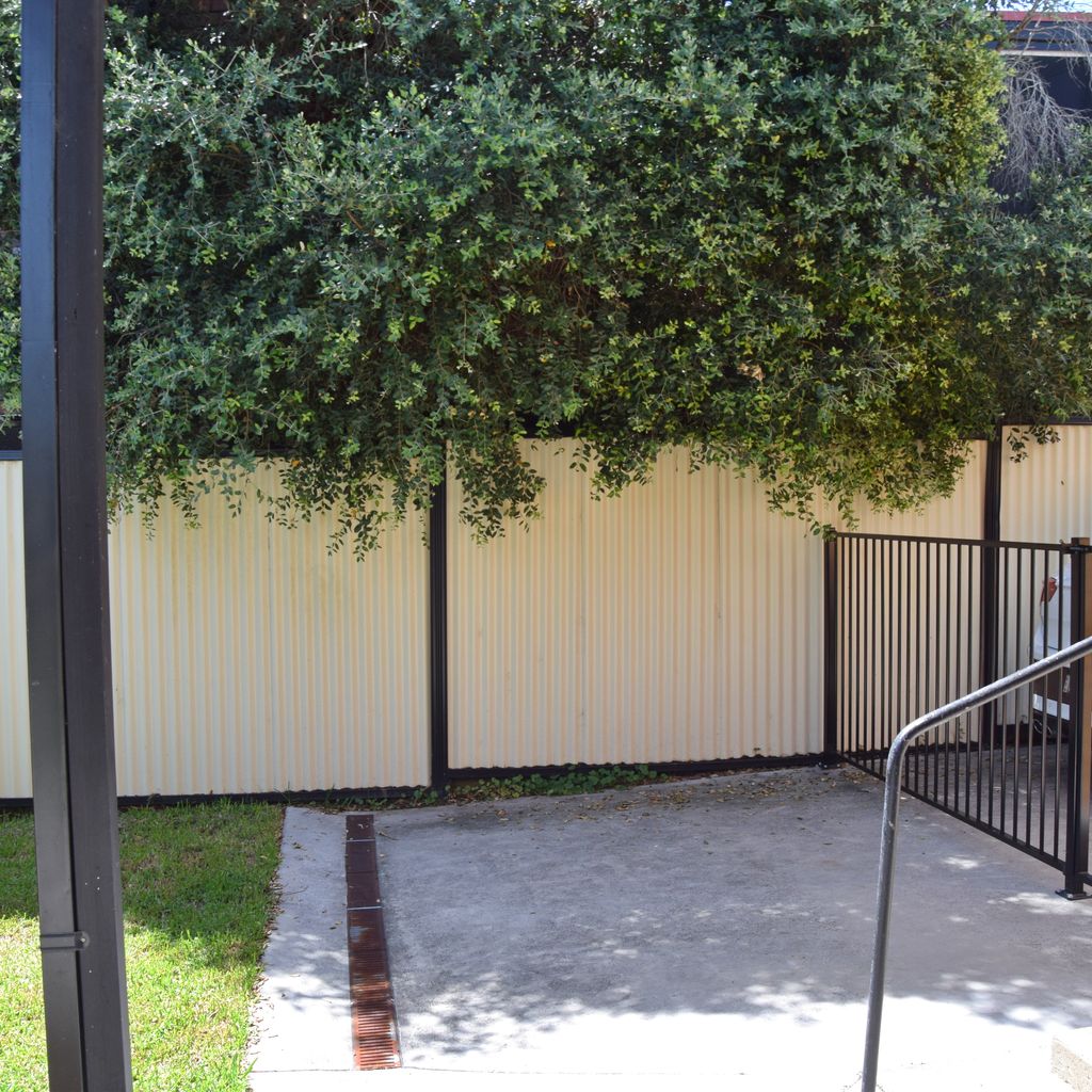 Back of carport with gate to keep the pets in whilst accessing your car.