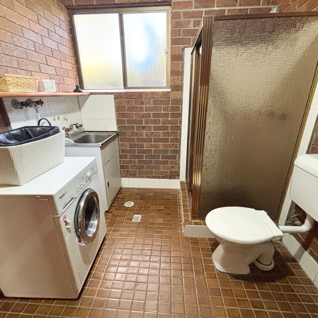 Downstairs combined laundry and bathroom. 