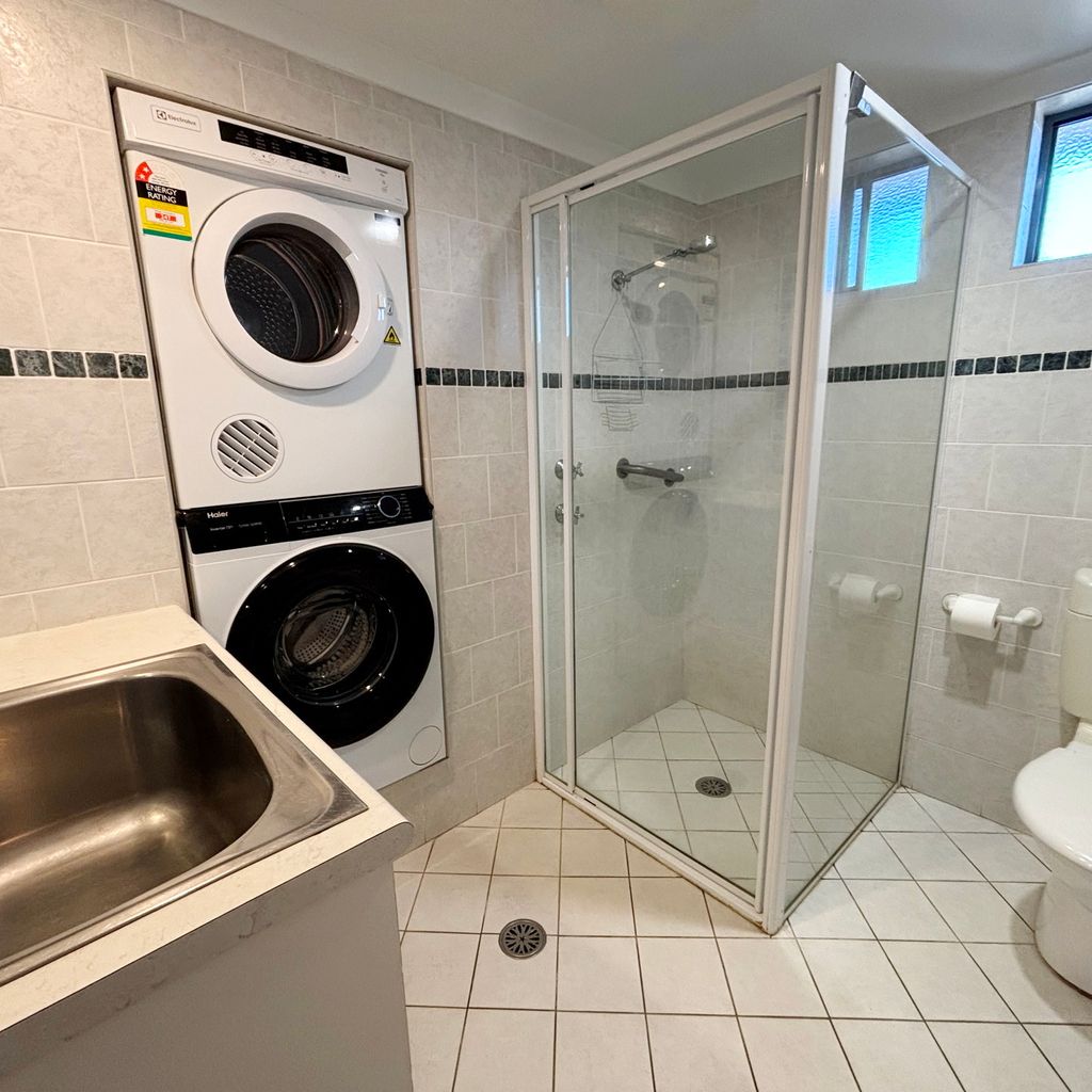 Combined laundry and bathroom.