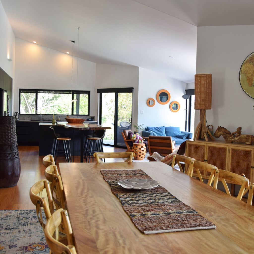 Dining area with kitchen in background.
