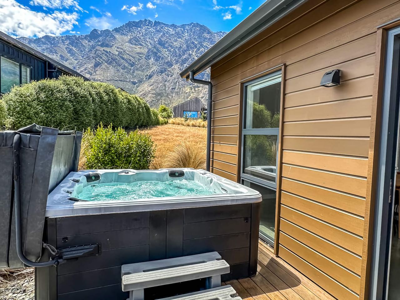 Outdoor spa with cover lifter