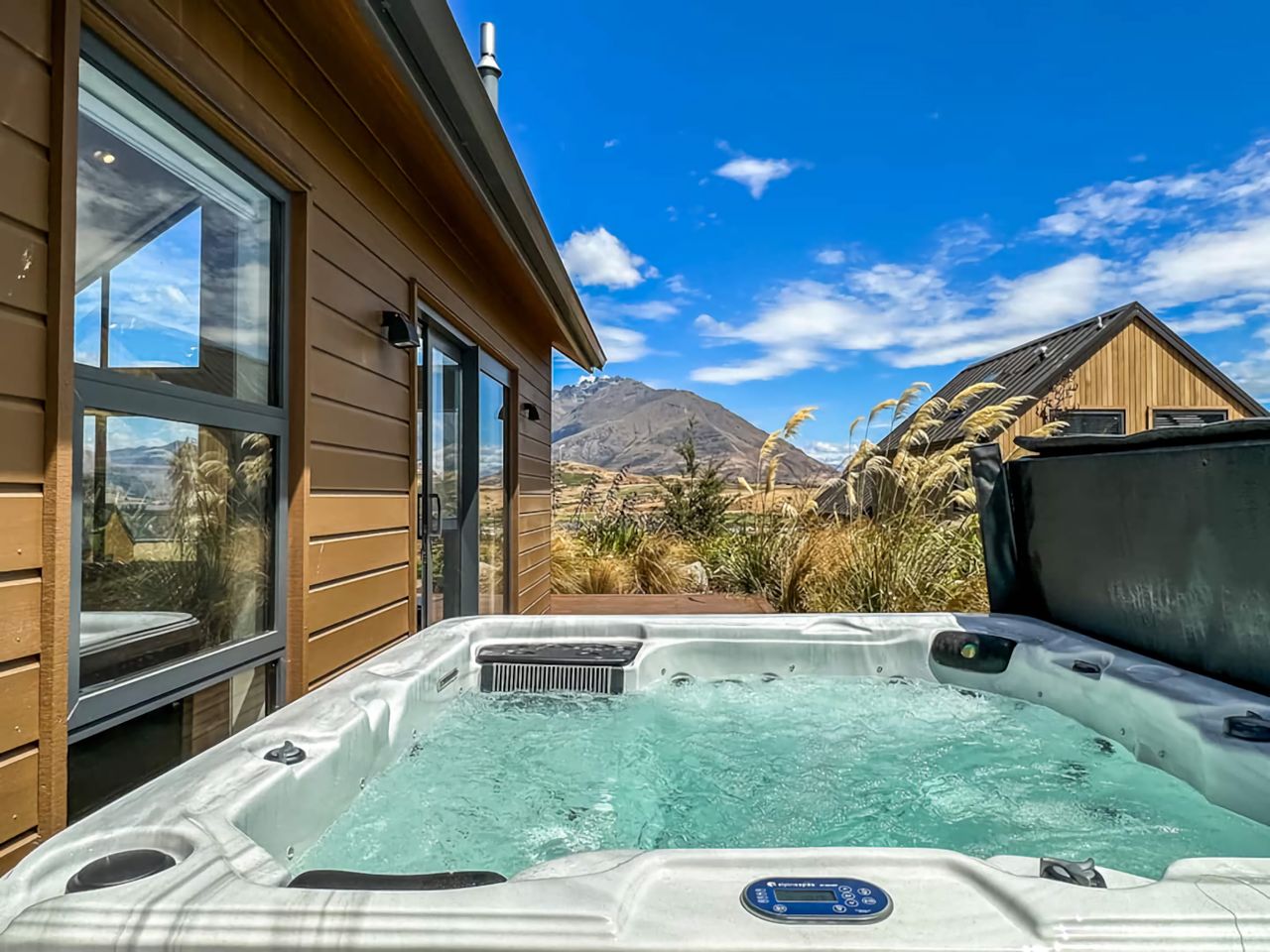 Relax in the outdoor spa pool with great views of the mountains