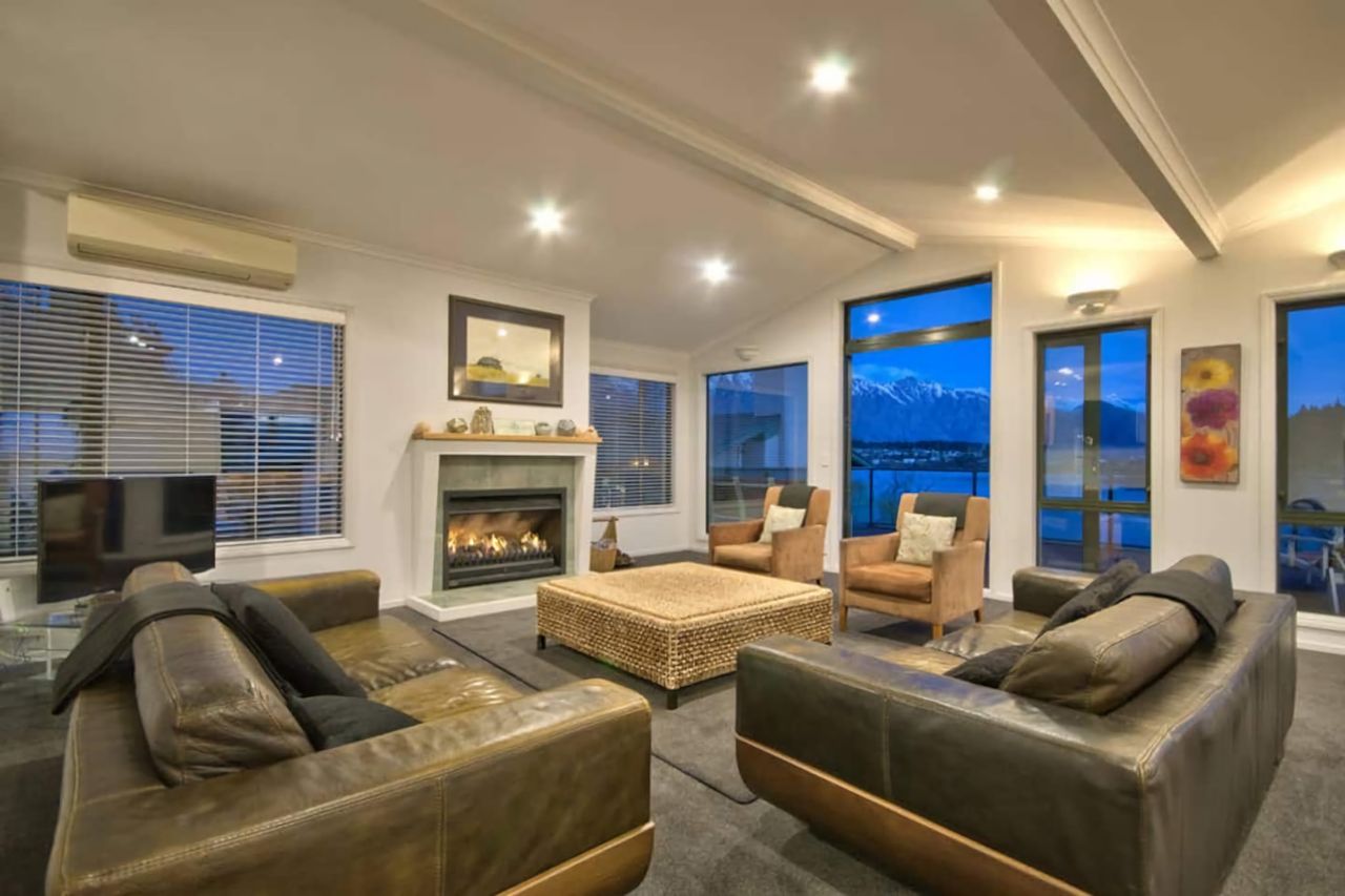 Lounge area with feature gas fire and access to balcony