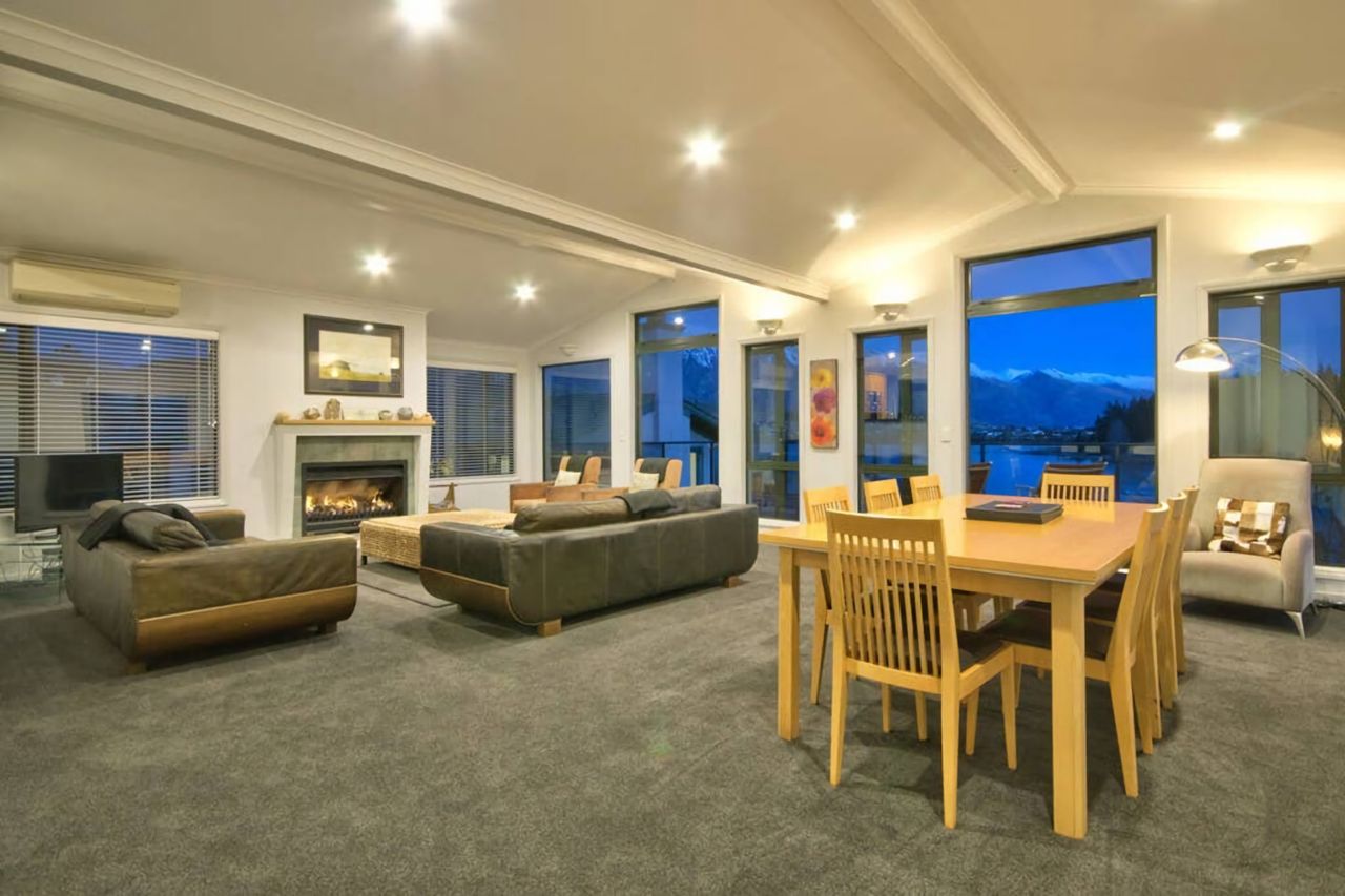 Open plan living dining room with access to balcony and views