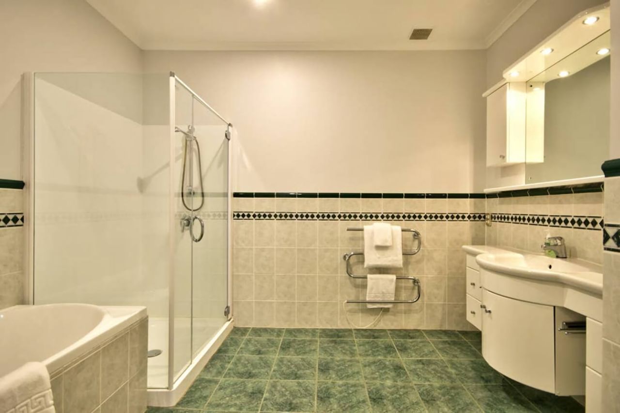 Mid-level bathroom with bath and shower (toilet separate). This is shared by three bedrooms.