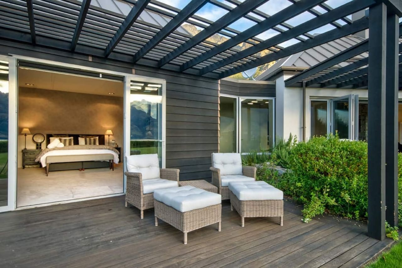 Master bedroom opens onto a deck area with chairs for relaxing