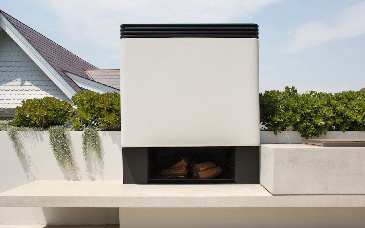 Sculptural elegance meets warmth at our outdoor fireplace.