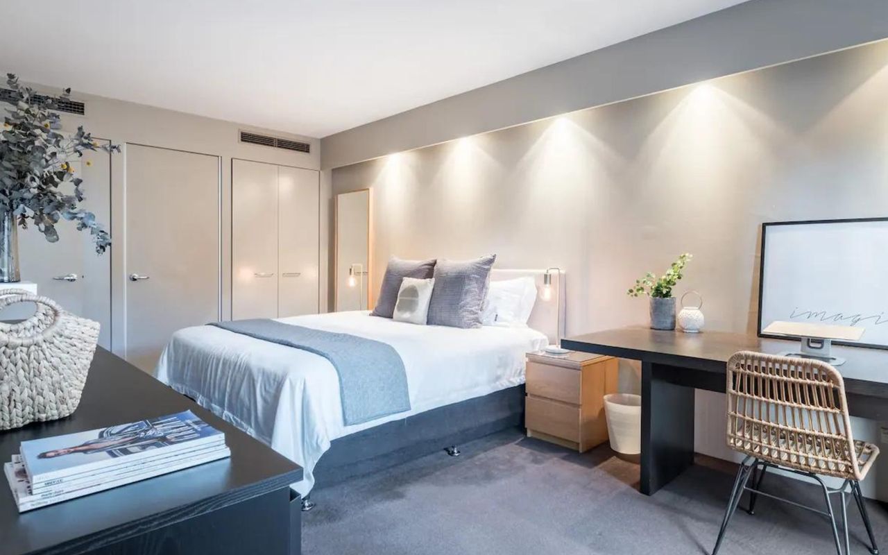 Serenity meets productivity in our stylish bedroom with a dedicated workspace.