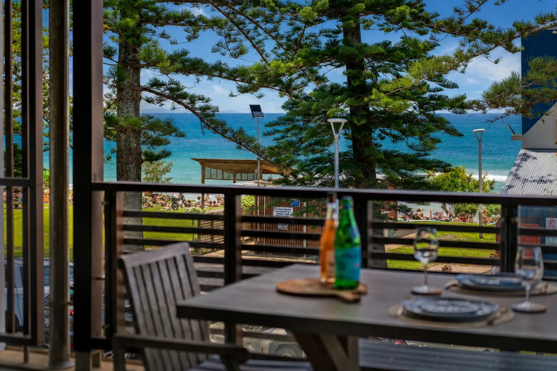 Deck table looking through Norfolk pines to the water