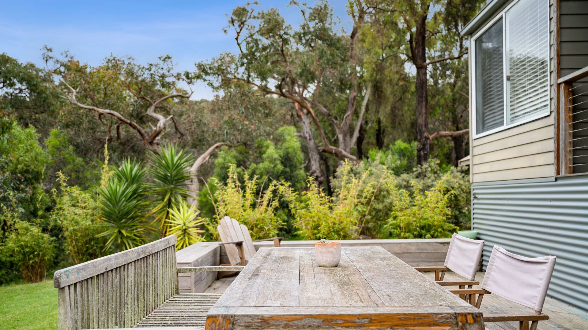 The porch leads to a lovely patio with outdoor furniture that overlooks a well-kept lawn. It's an excellent spot for a sunny breakfast, brunch, or even a romantic dinner under the stars.