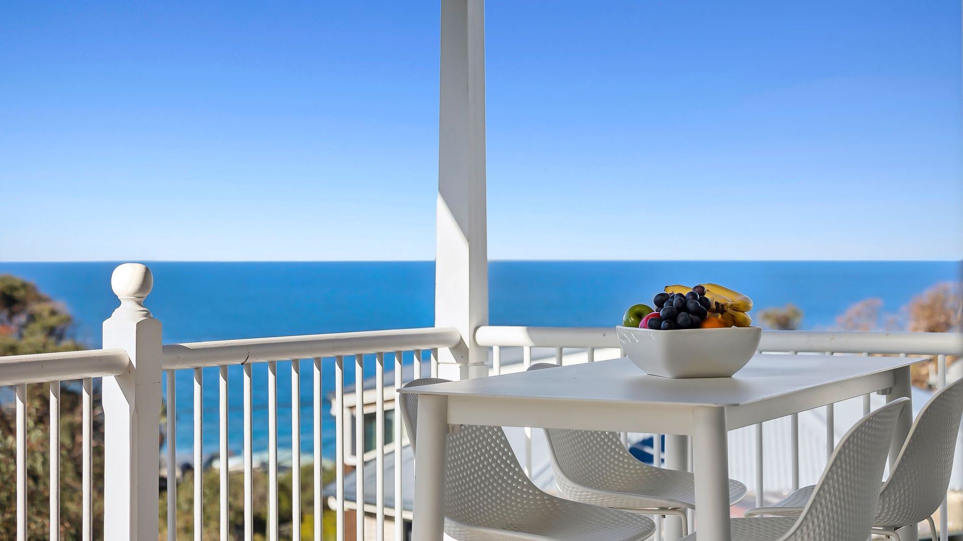 Outdoor deck with a peaceful blue water outlook.