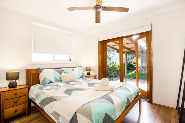 Queen bedroom with doors opening onto patio