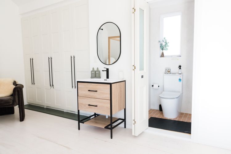 Small bathroom with shower and toilet and vanity in main room