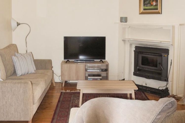 Lounge area with fireplace. It also has lovely french doors that open to the verandah