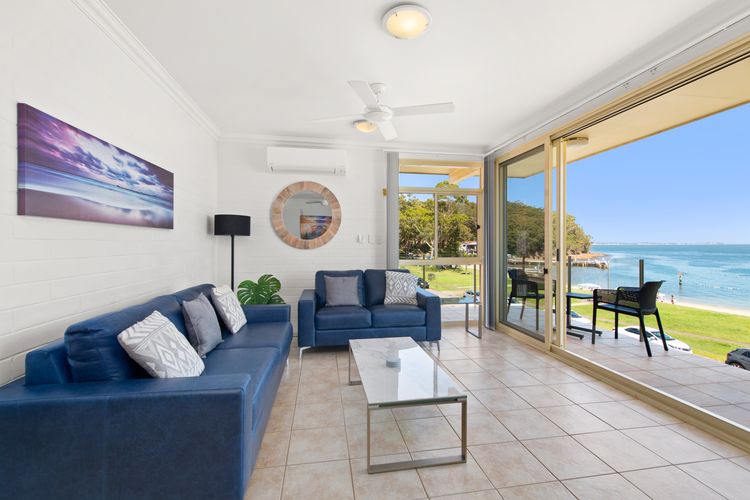 The open living space wuth celling fan and big screen TV.