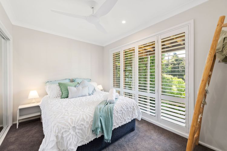 Bedroom 5 has a Queen bed, a built-in robe, a ceiling fan, and air-conditioning.