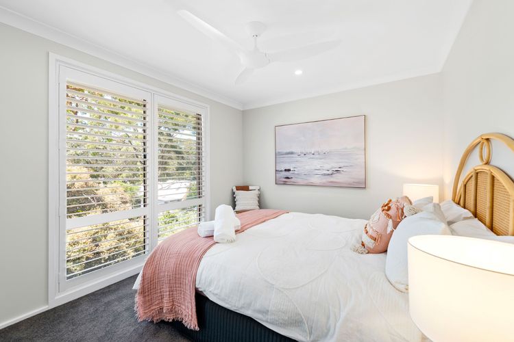 Bedroom 2 has a Queen bed, a built-in robe, a ceiling fan, and air-conditioning.