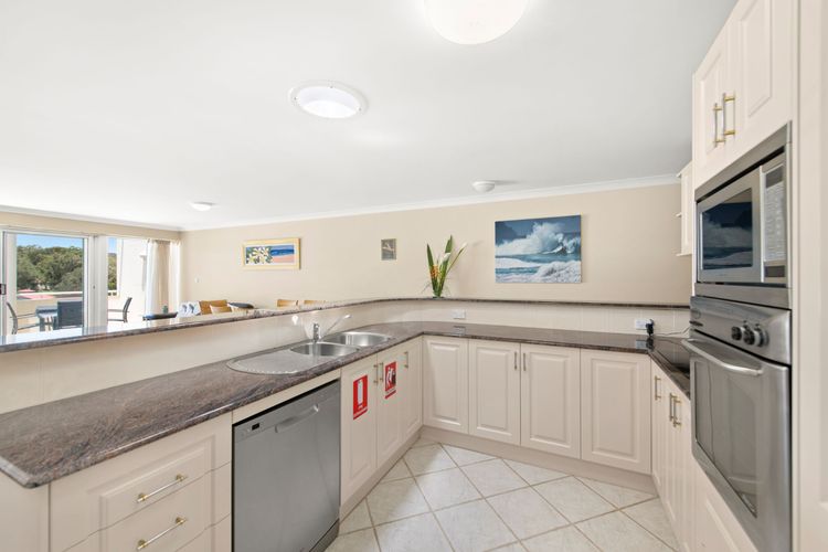 Full kitchen with a full-sized fridge and freezer, an oven, a stove, a microwave, a dishwasher, and more.