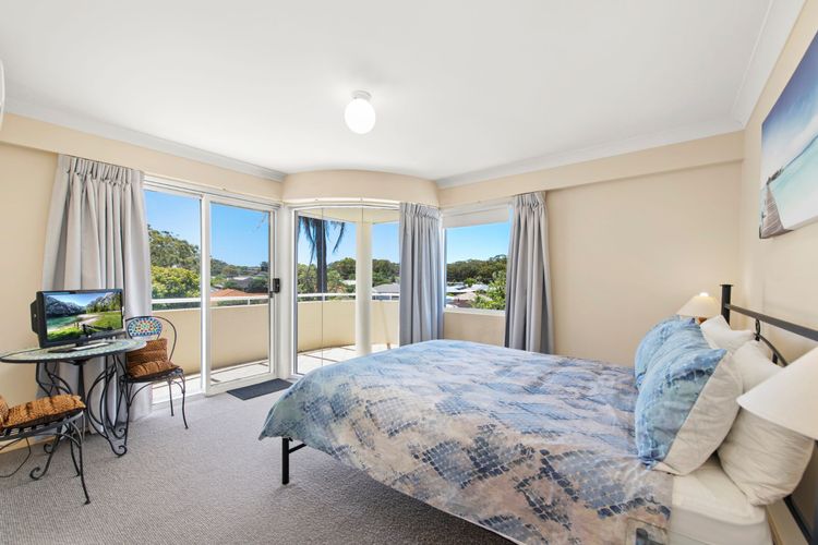 Bedroom 1: Queen bed, a built-in robe, balcony access, and an ensuite with a shower and toilet.