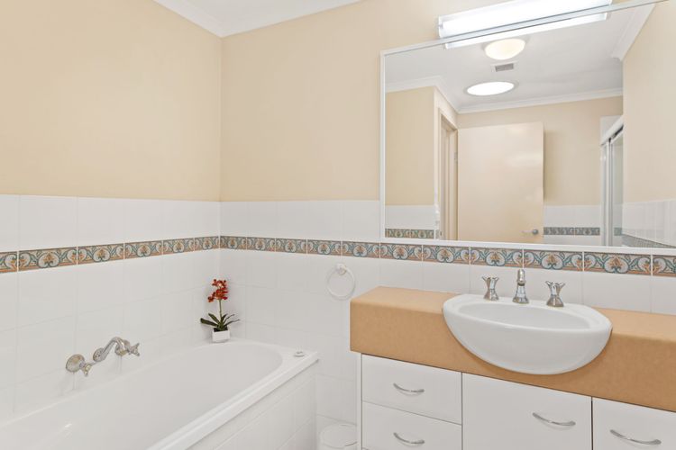 The main bathroom has a shower, a bathtub, and a separate toilet.