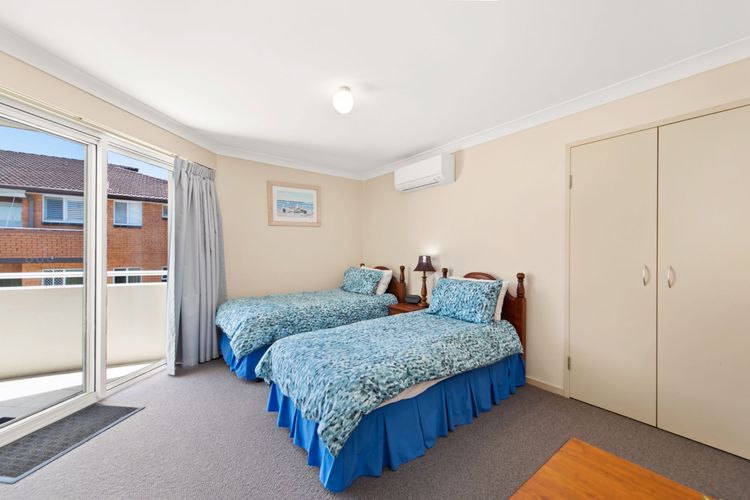 Bedroom 3: 2 Single beds, balcony access, and a built-in robe