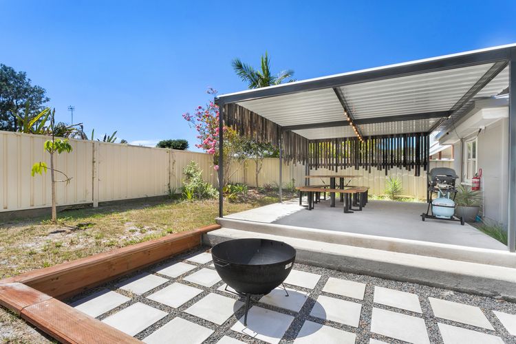 Large outdoor entertaining area with table and chairs and BBQ