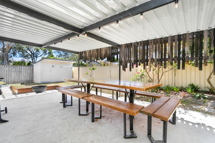 Large outdoor entertaining area with table and chairs and BBQ
