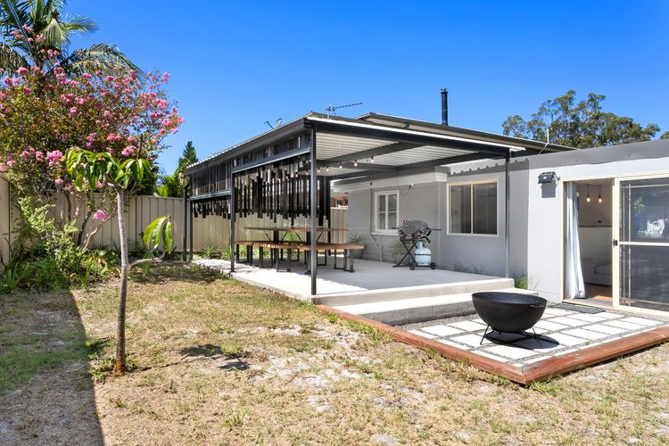Large outdoor entertaining area with table and chairs and BBQ
