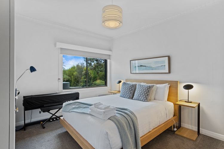 Bedroom 2 - Queen with partial water view, tv and keyboard