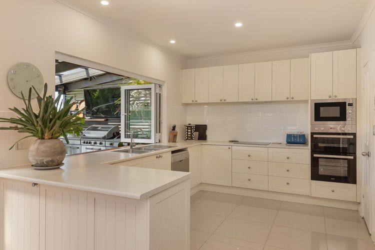 Spacious kitchen with bifold windows. Induction stove top, large fridge and butlers pantry with laundry.