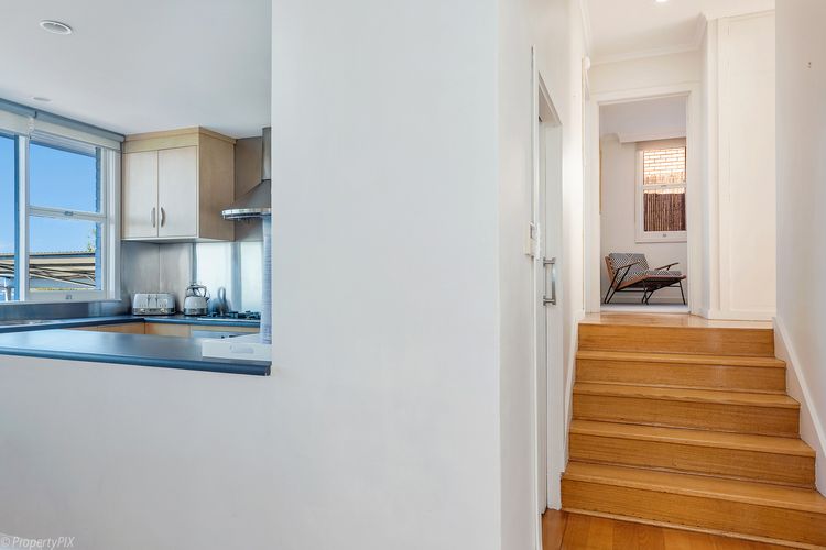 5 Stairs leading to the upper level from the entry level. Ducted heating panel is on the left side of wall.