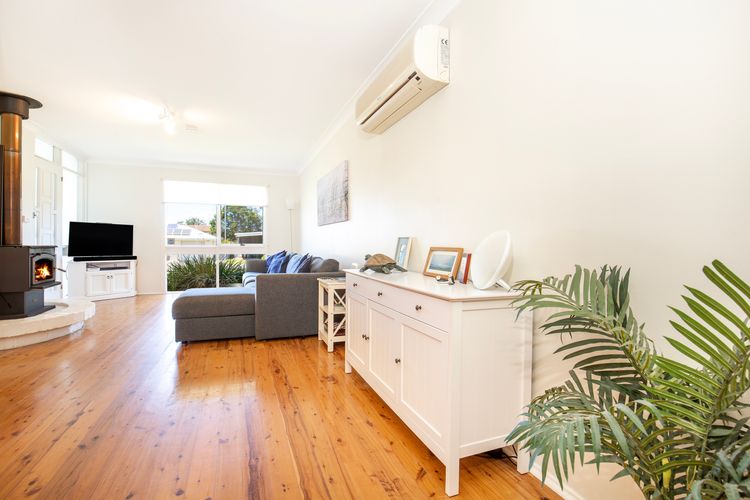 Beautiful light filled living area with combustion fireplace and huge couch