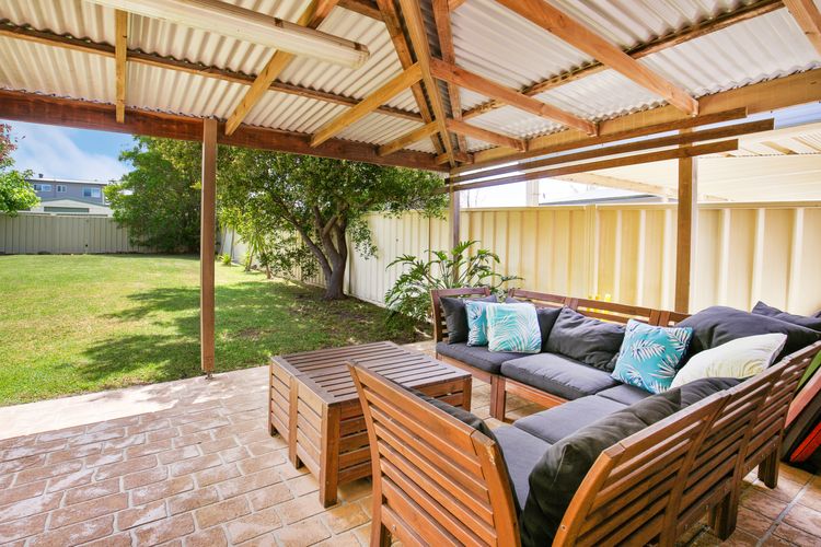 Outdoor lounge overlooking fully fenced level garden