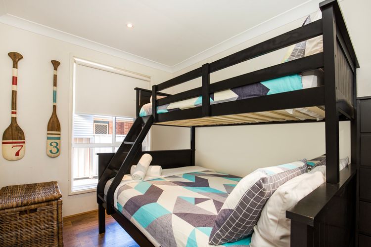 Tri bunk room with double bed on bottom and single bed on top