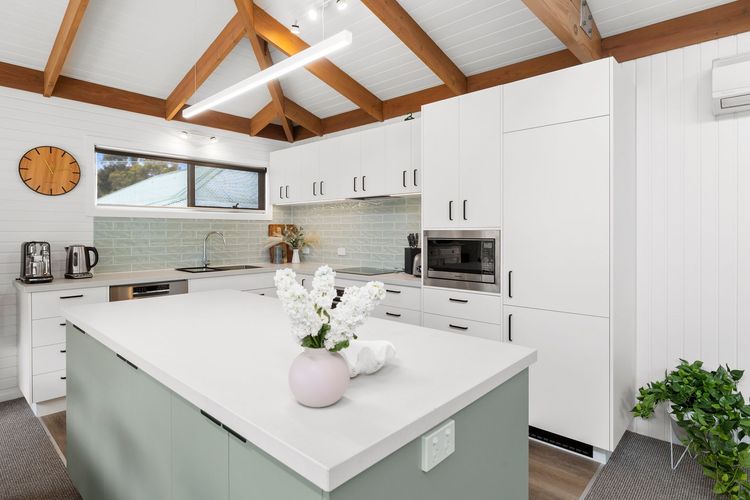 It offers a full kitchen with modern amenities and appliances.