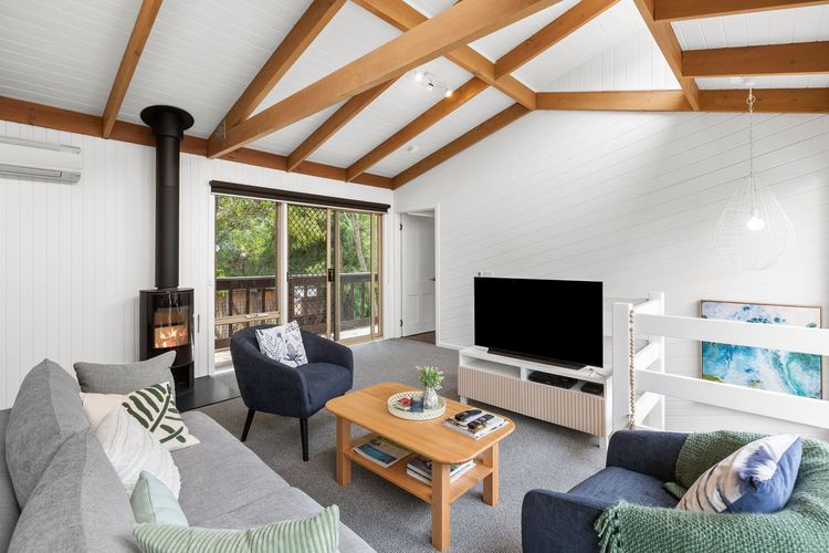 Spacious and airy living room with Wi-Fi, a flat-screen TV, a surround sound system, and a Bluetooth speaker.