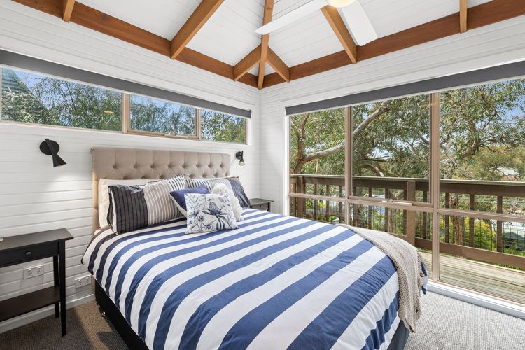 Bedroom 3: Queen bed, a built-in robe, a TV a study desk, and access to a private balcony. It also has an ensuite with a shower and toilet.