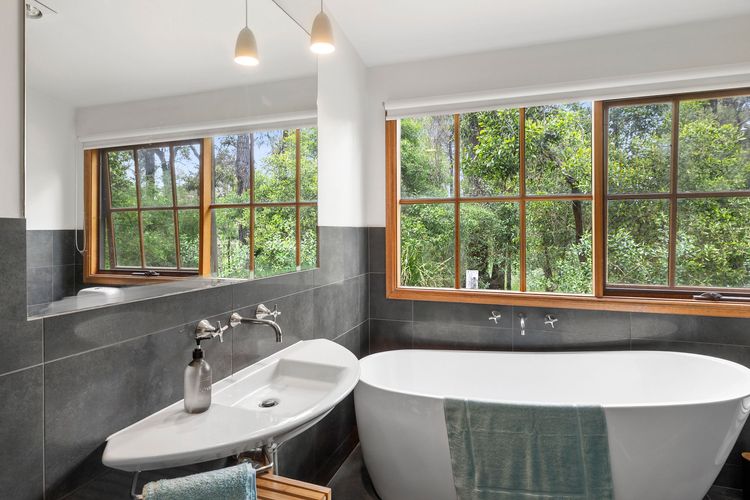 The third bathroom has a shower, bathtub, and toilet.