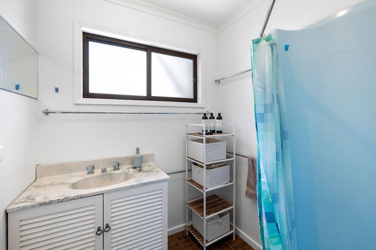 The bathroom has a clean shower and toilet.