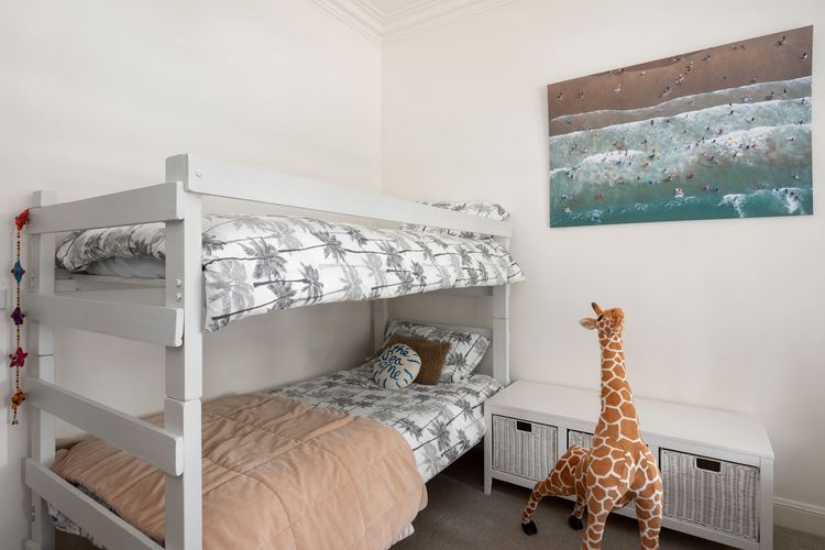 Bedroom 3 has a Bunk bed and a single bed with a ceiling fan and a walk-in robe. This is designed for your kids, as it even has an adorable giraffe stuffy that makes the room fun.