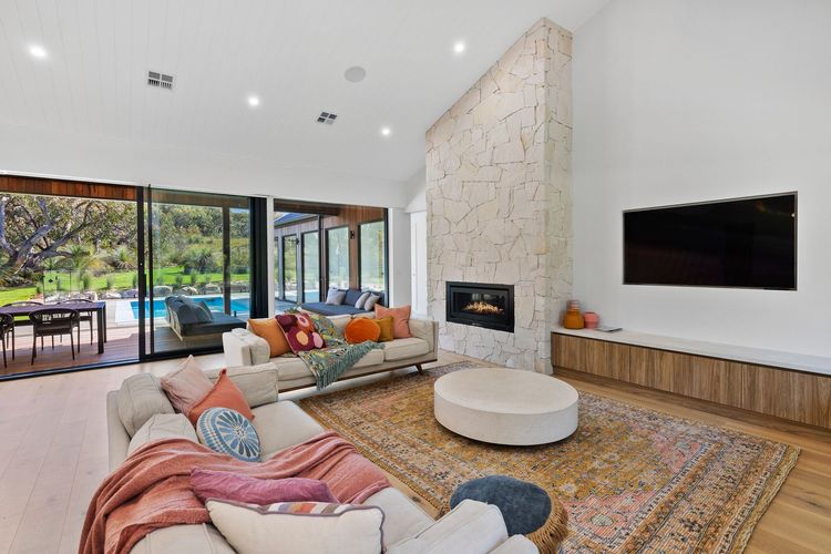 Living room is cosy and inviting, with Wi-Fi, a flat-screen TV with Netflix, a modern fireplace, and ducted air conditioning.