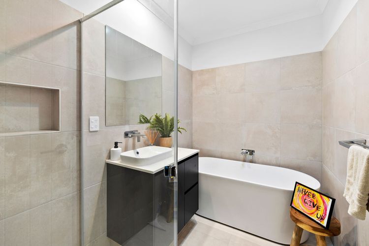 The main bathroom has a shower, a bathtub, and a separate toilet.